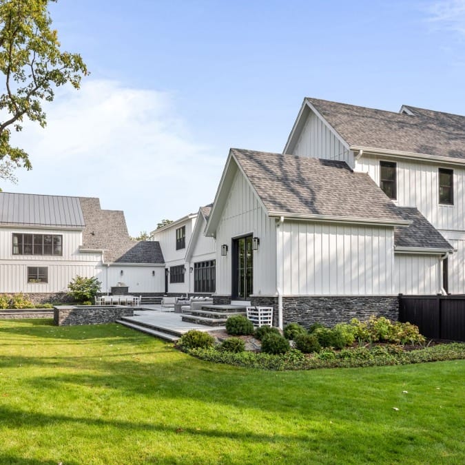 Natural Stone Exterior with White Board and Batten Siding Natural Stone Exterior with White Board and Batten Siding
