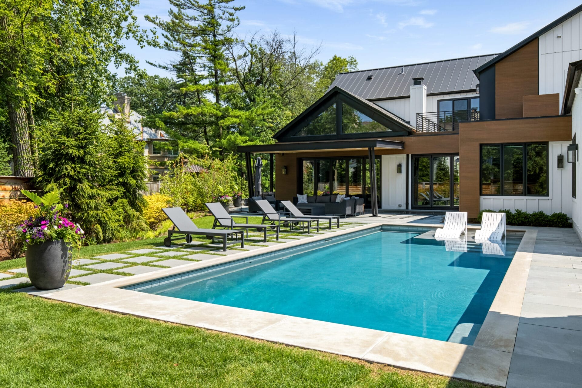 Modern House With A Swimming Pool And Outdoor Loungers